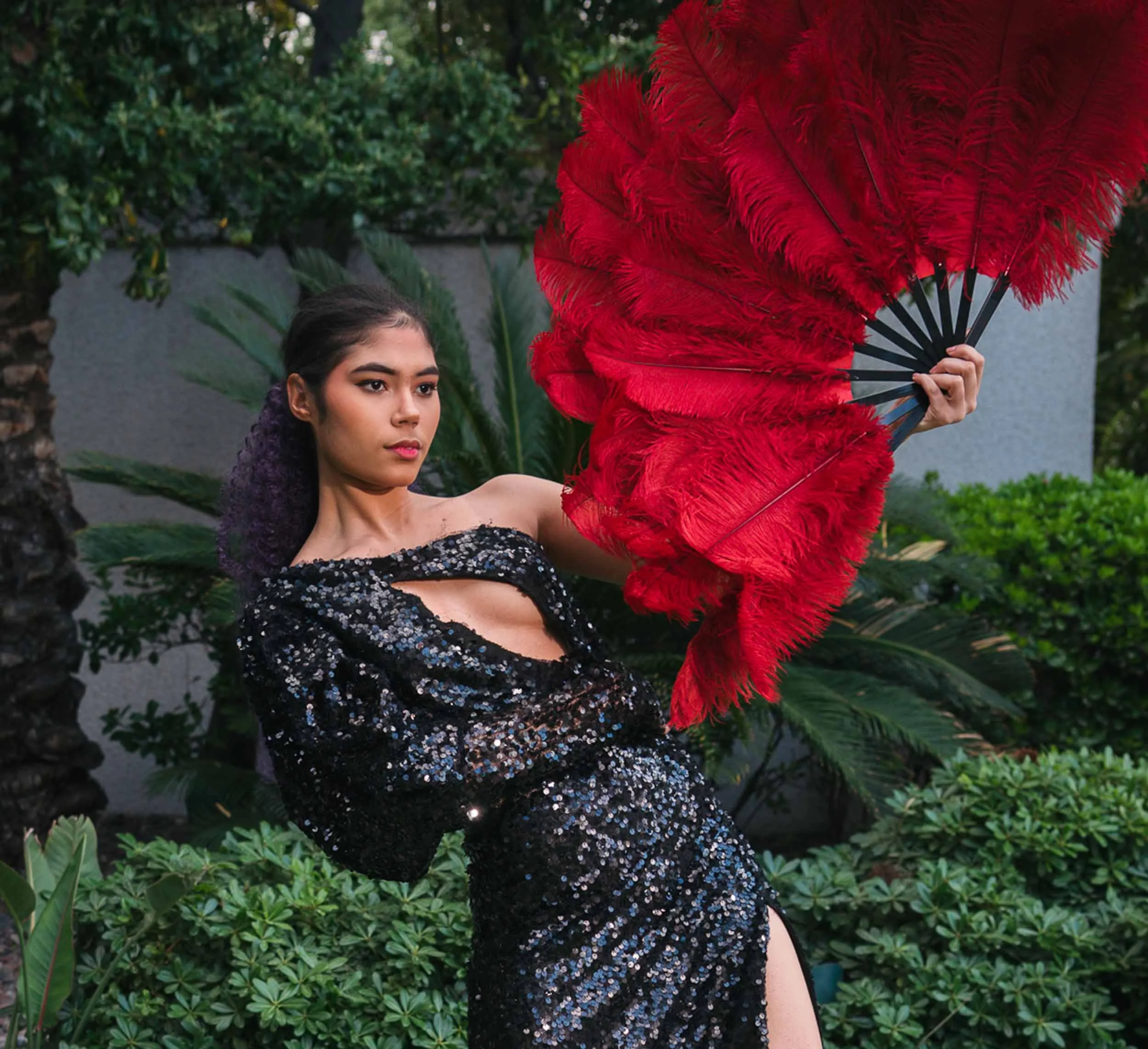 young woman with colorful feather fan