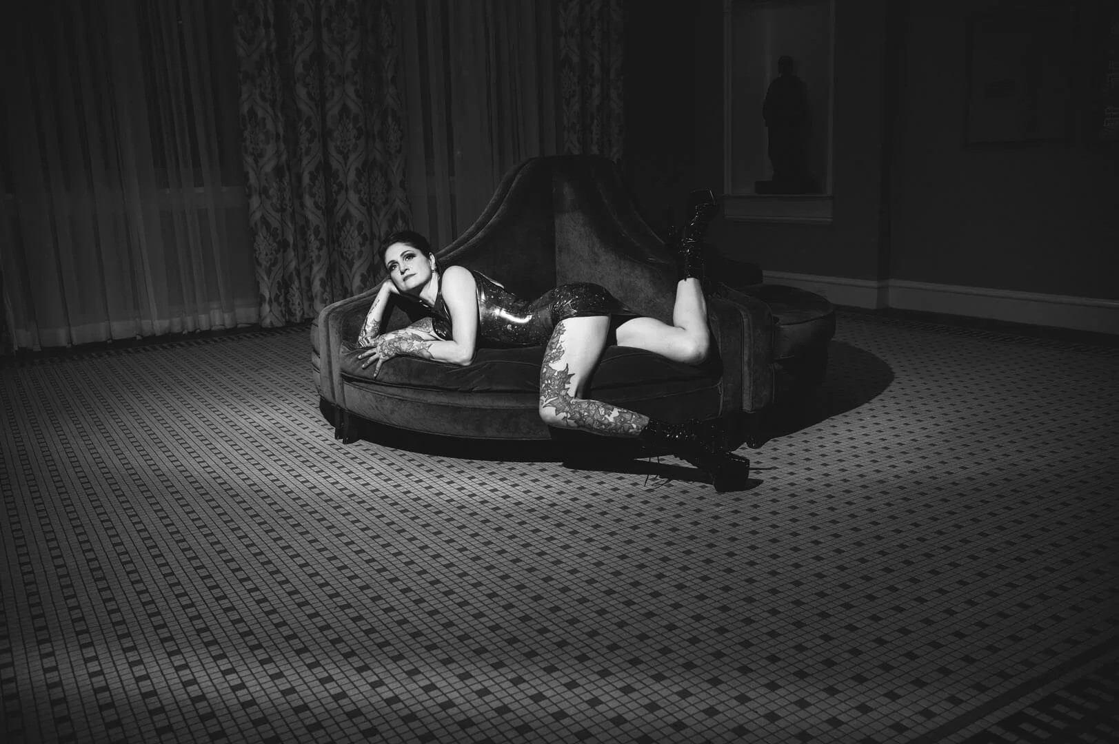 woman lying on round sofa