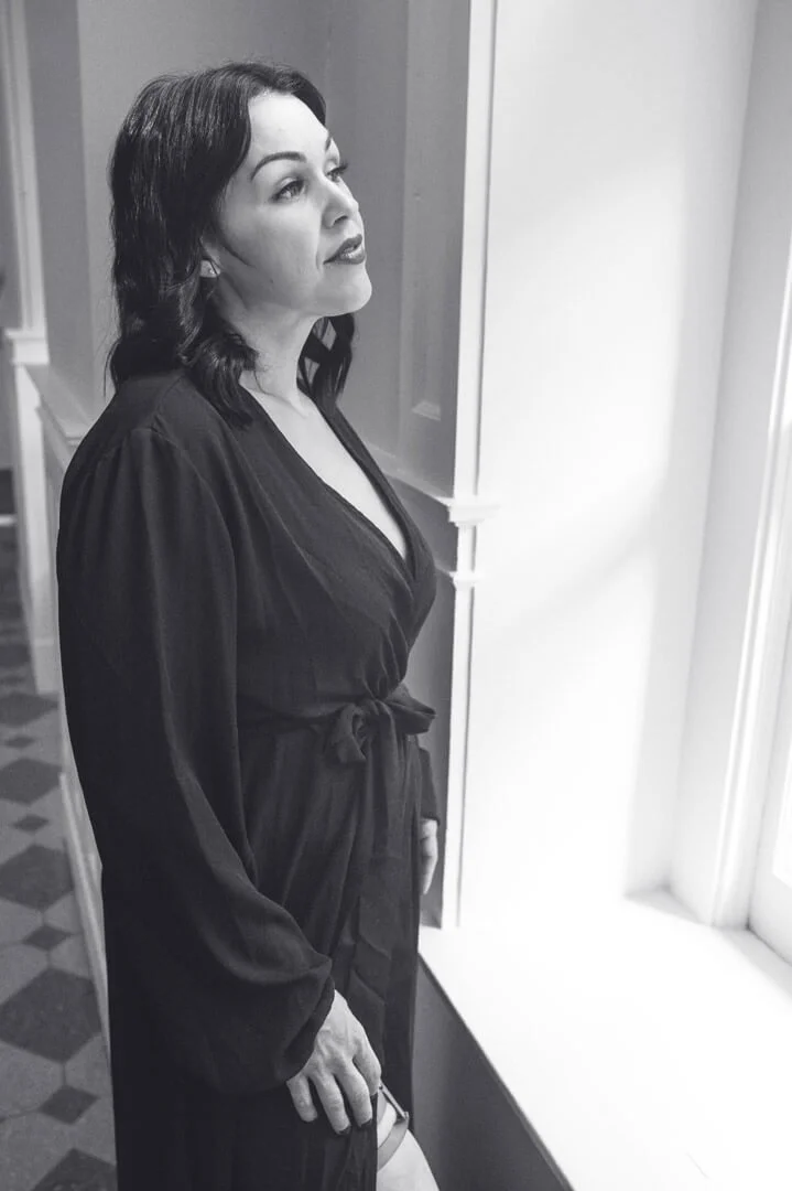 woman in robe in window light