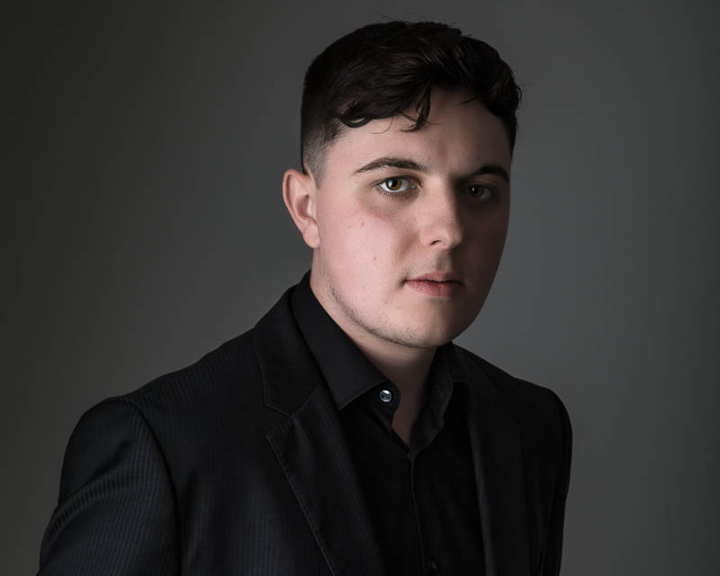 Professional headshot of a graduate student in studio