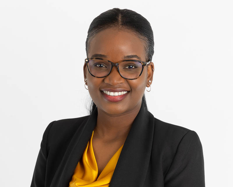 Guided studio portrait with a blazer against a seamless background
