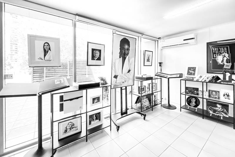 Bright modern photography studio interior with Profoto lighting and tethered Apple display