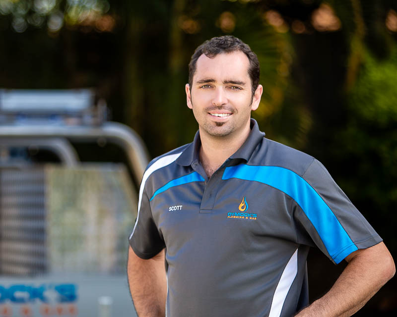 Professional headshot of a tradesperson in branded work gear