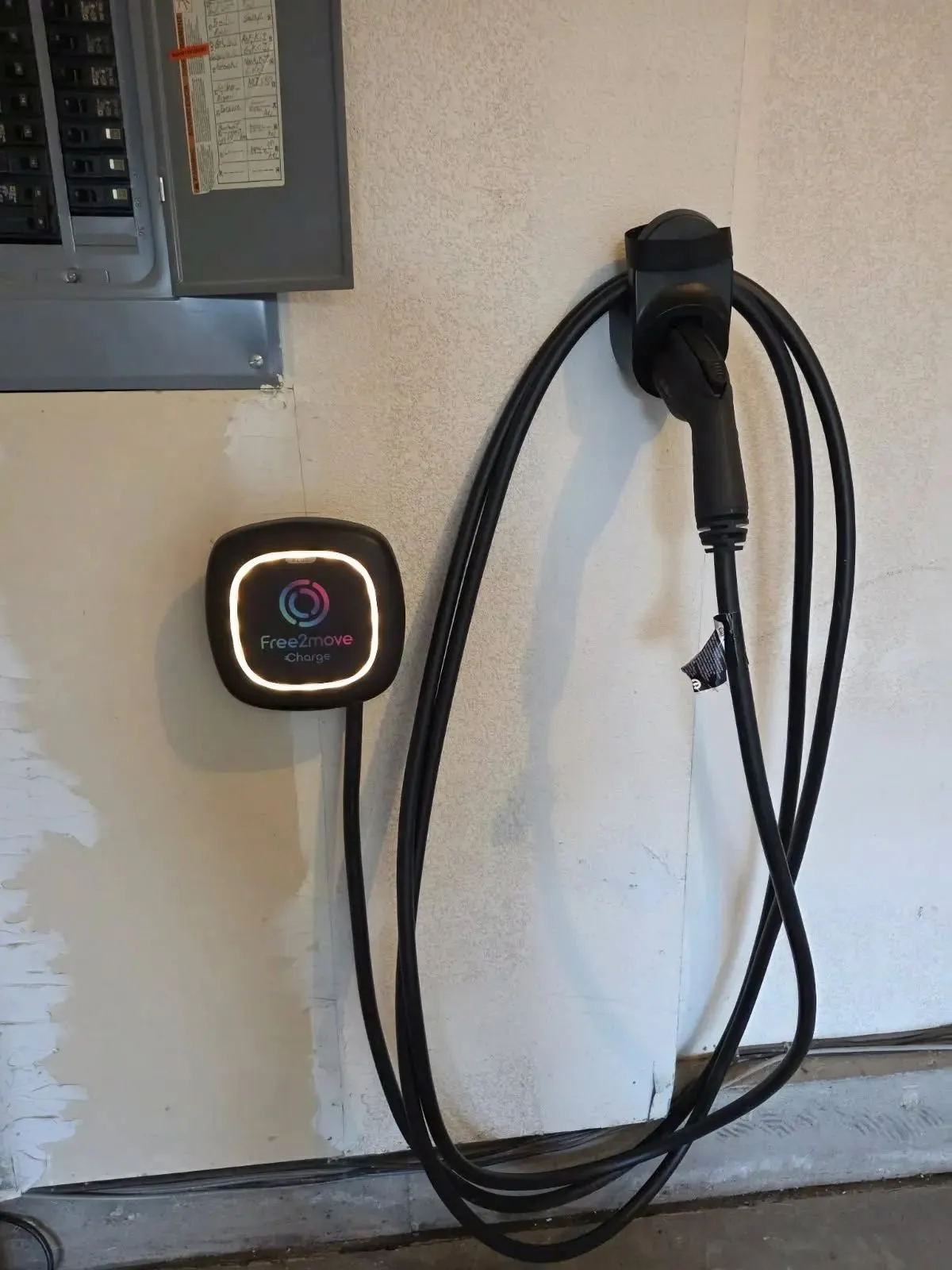 Free2move Charge Level 2 EV charger installed next to the electrical panel in a Northern Colorado garage