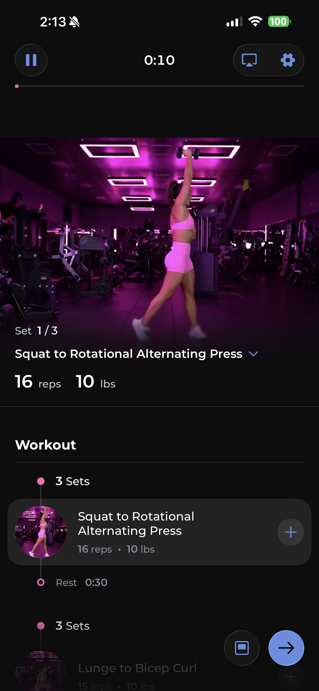 Actual NDF app workout screenshot showing Nikki demonstrating a squat to rotational alternating press