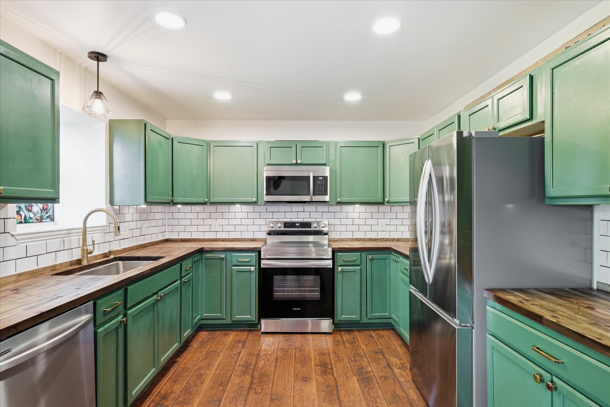 Updated kitchen with butcher-block countertops and brass hardware at 208 Cory Court