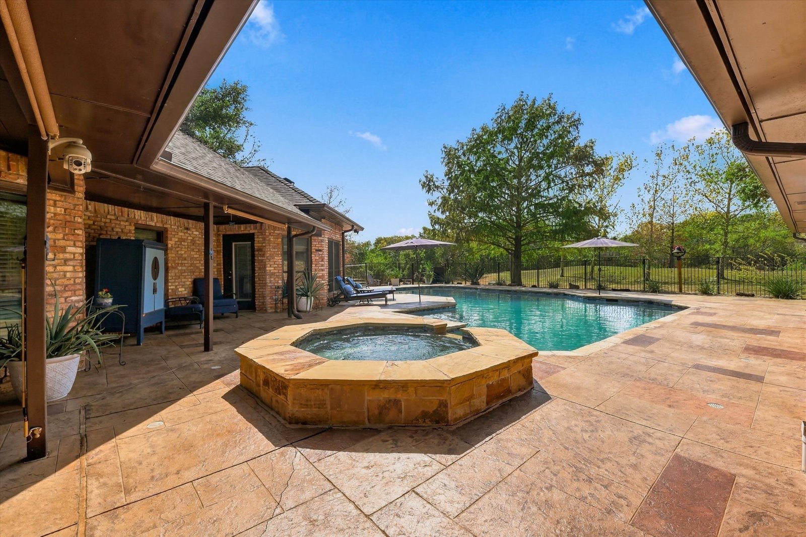 Refinished swimming pool and covered outdoor living area at 3801 Post Oak Road