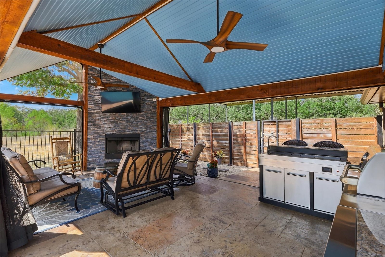 Covered outdoor kitchen and entertaining area at 3801 Post Oak Road