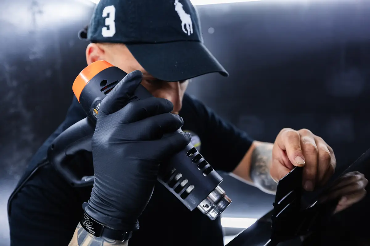 Window tints on car with rain drops