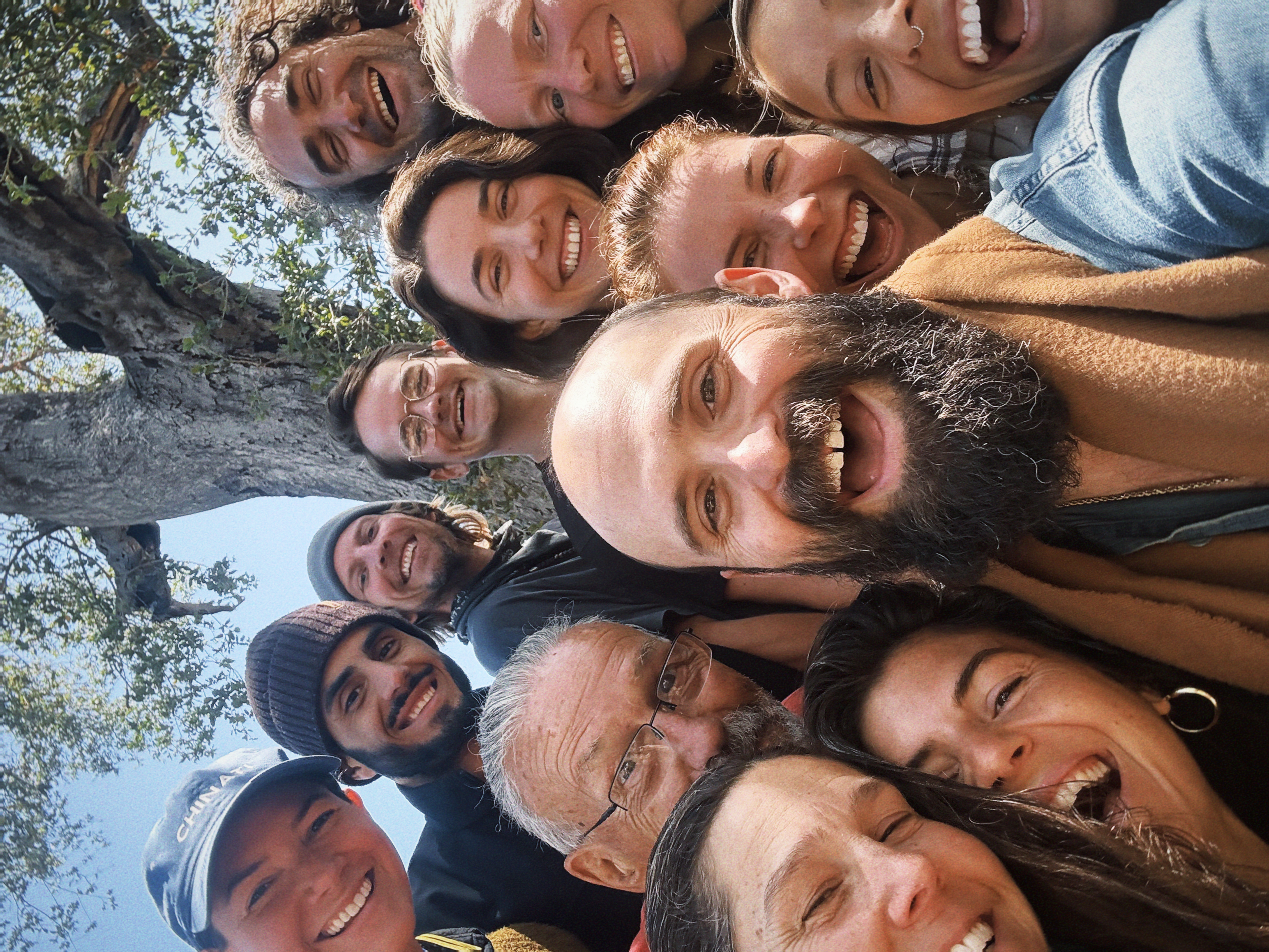 Sacred Tree Keepers community gathered outdoors under a tree
