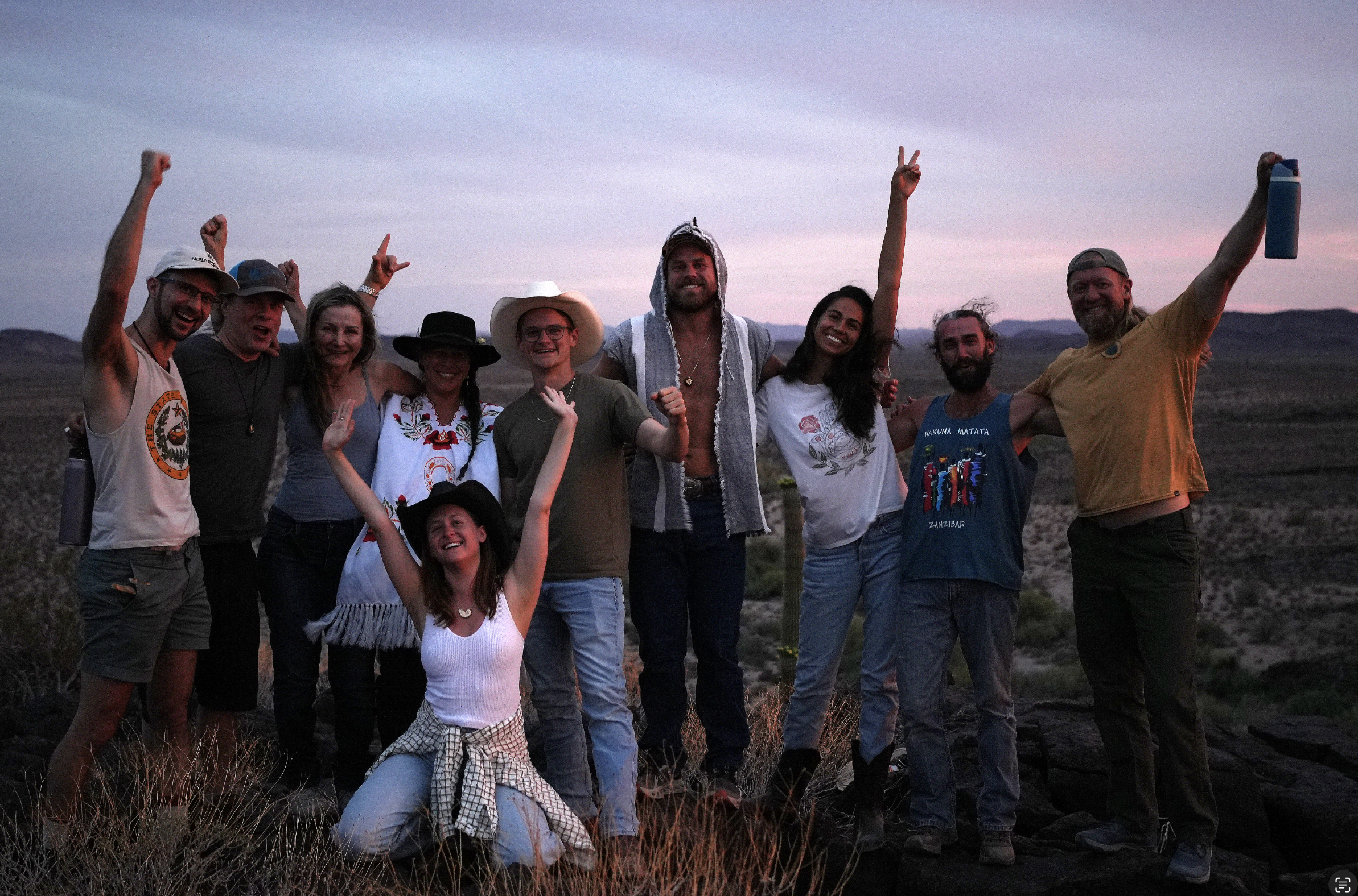 Sacred Tree Keepers community gathered outdoors at dusk
