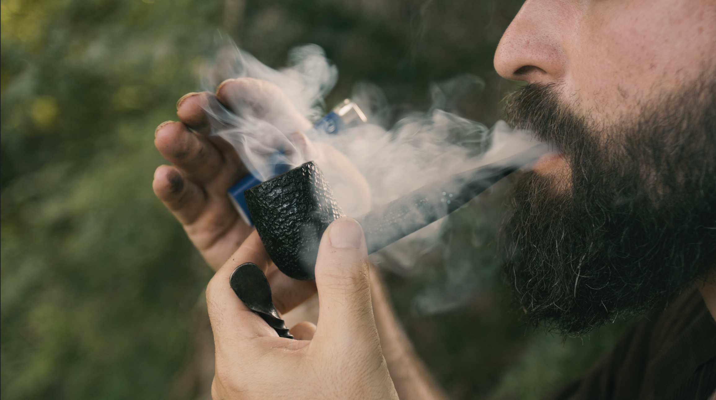 Lighting a tobacco pipe outdoors