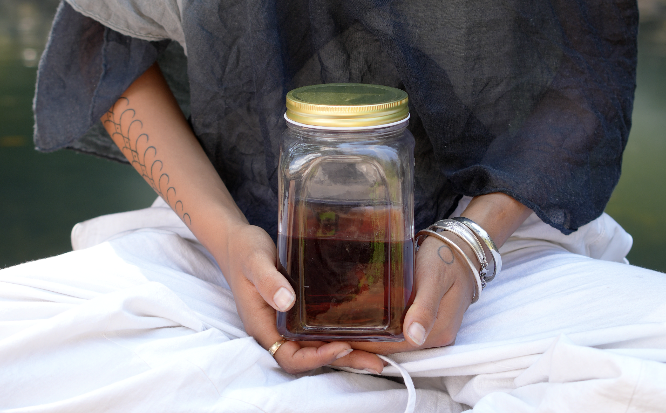 A person holding a jar of tree medicine