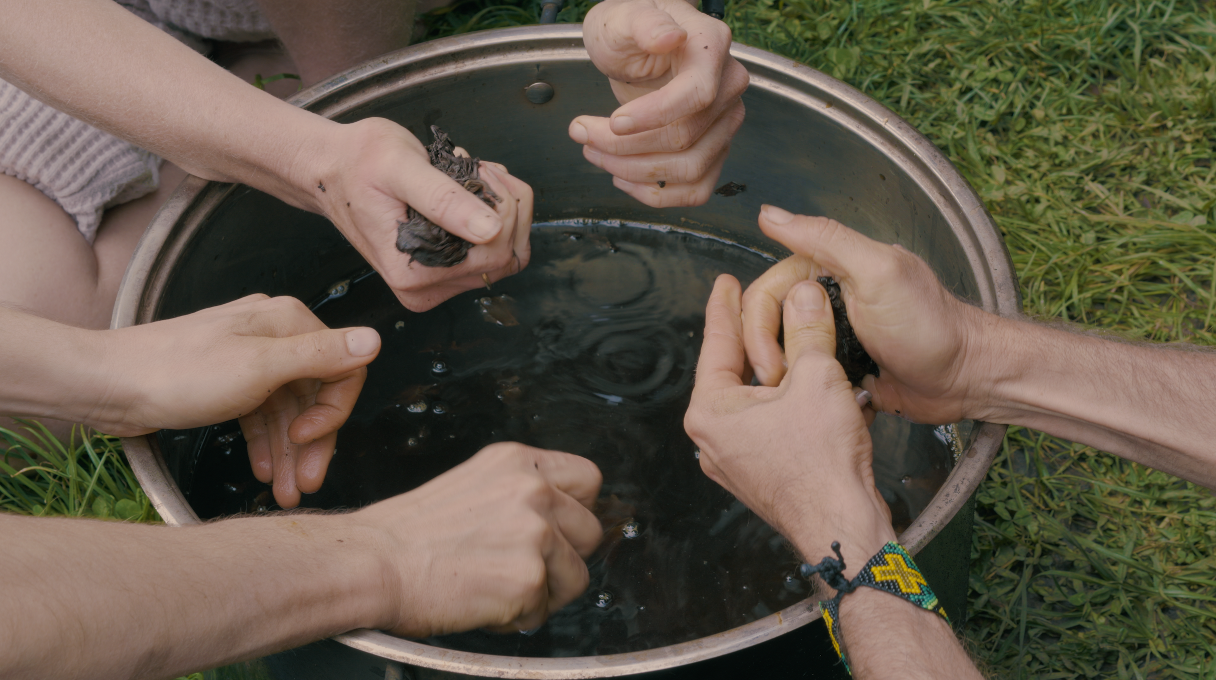 Hands working together to prepare Tobacco
