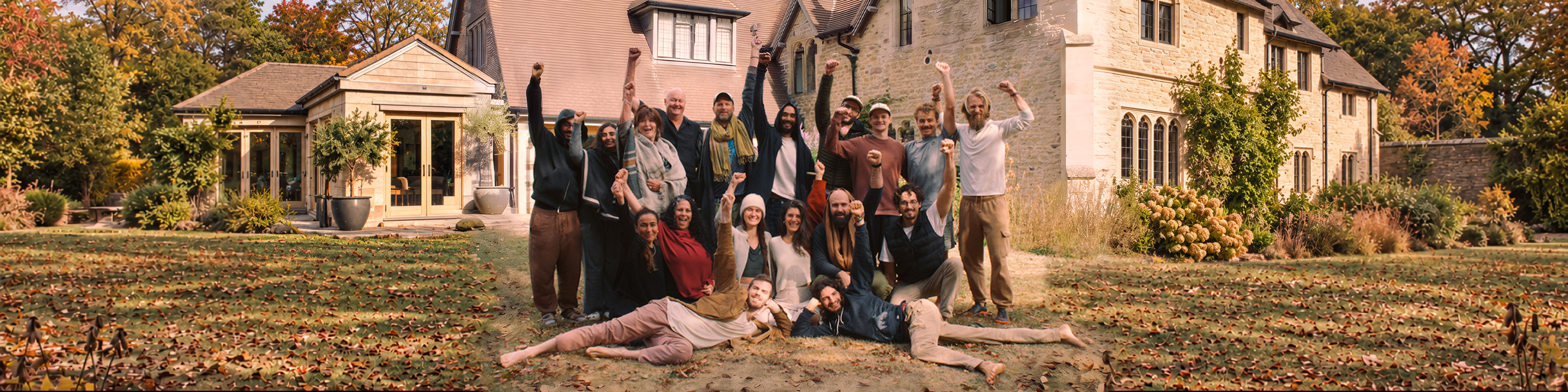Sacred Tree Keepers community gathered outside a stone house