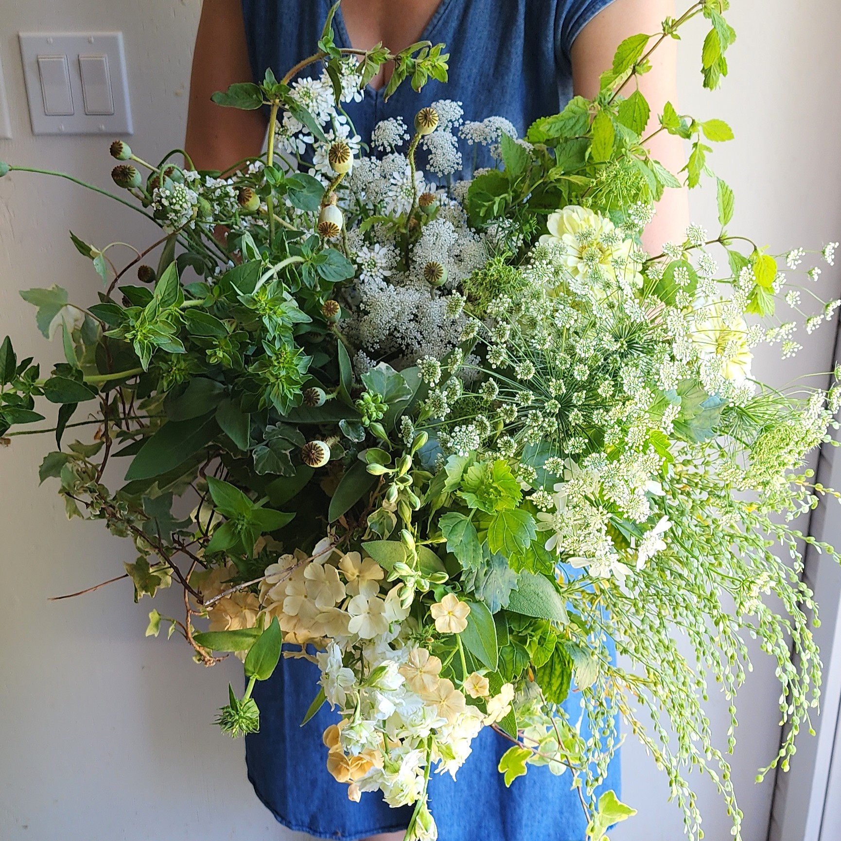 Paula holding a bundle of green flowers