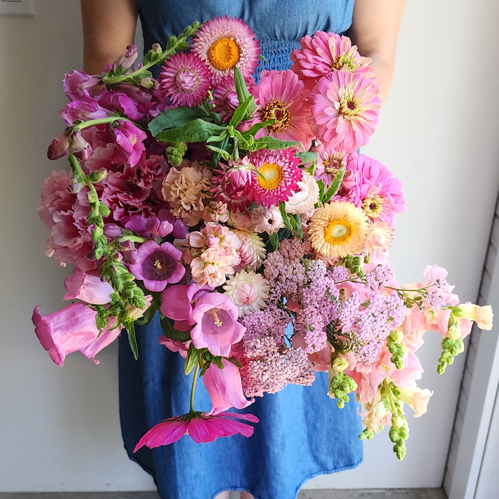 Paula holding a bundle of pink flowers