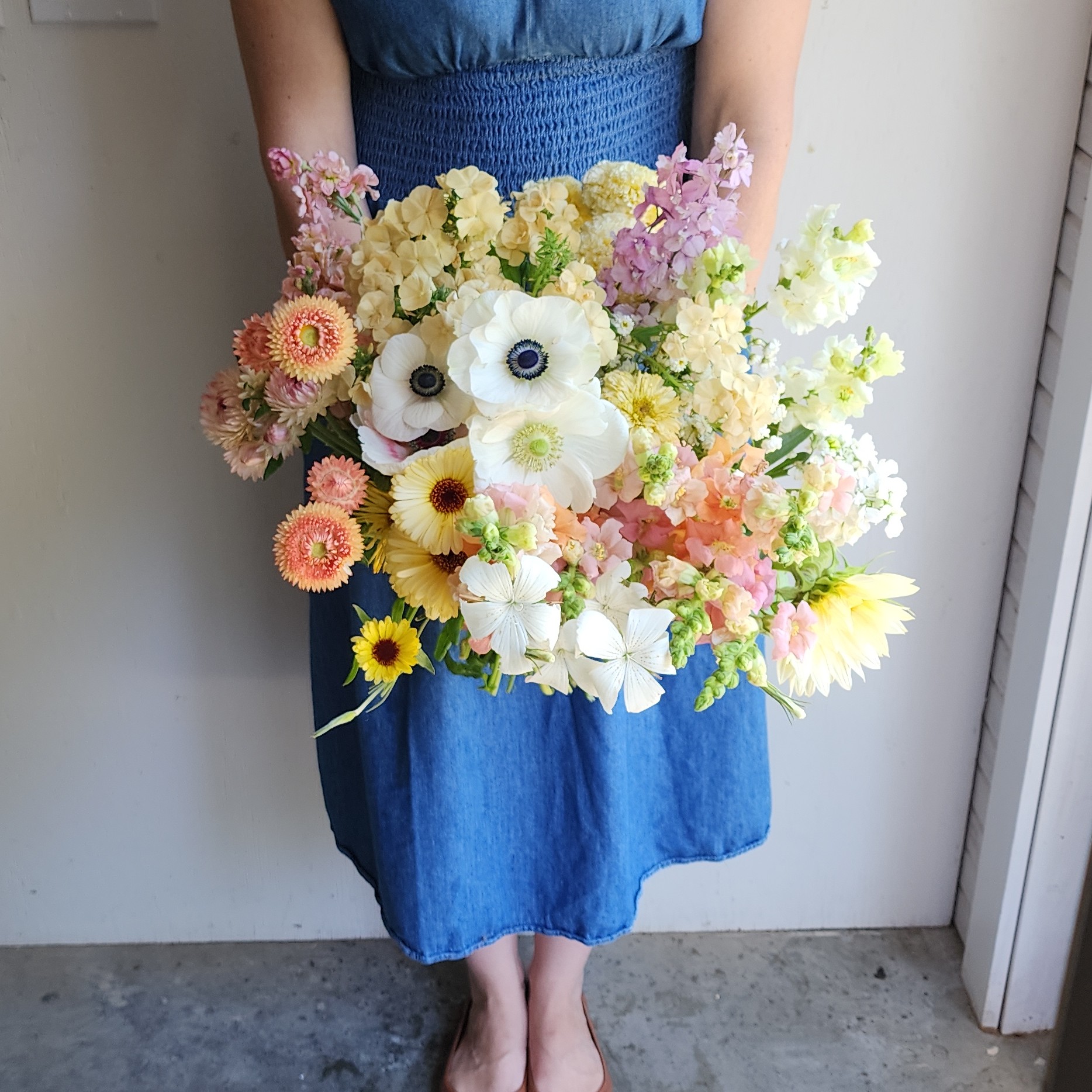 Paula holding a bundle of pastel flowers