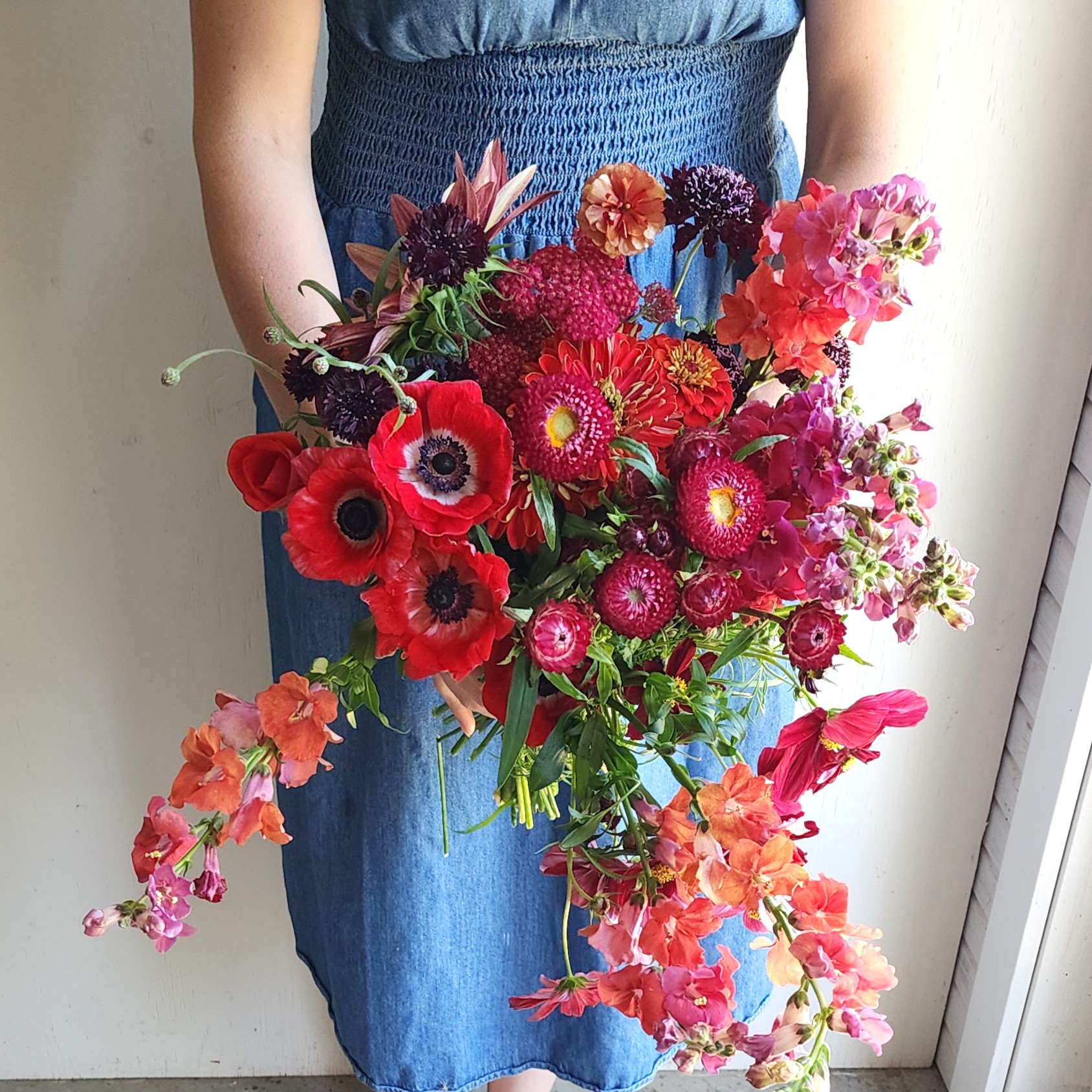 Paula holding a bundle of red flowers