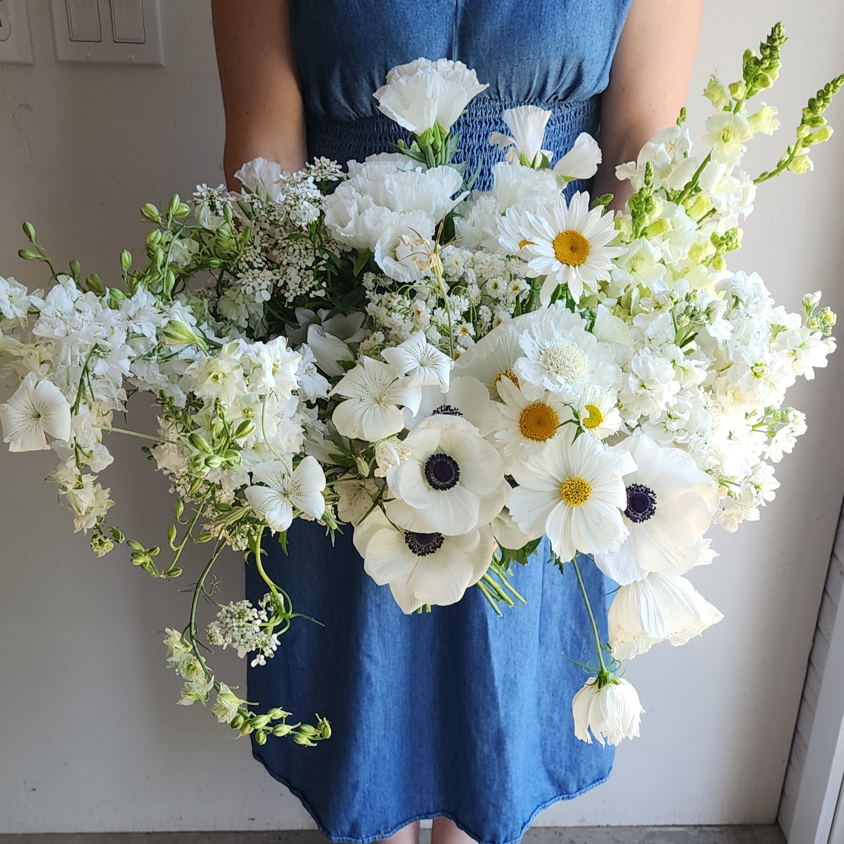 Paula holding a bundle of white flowers