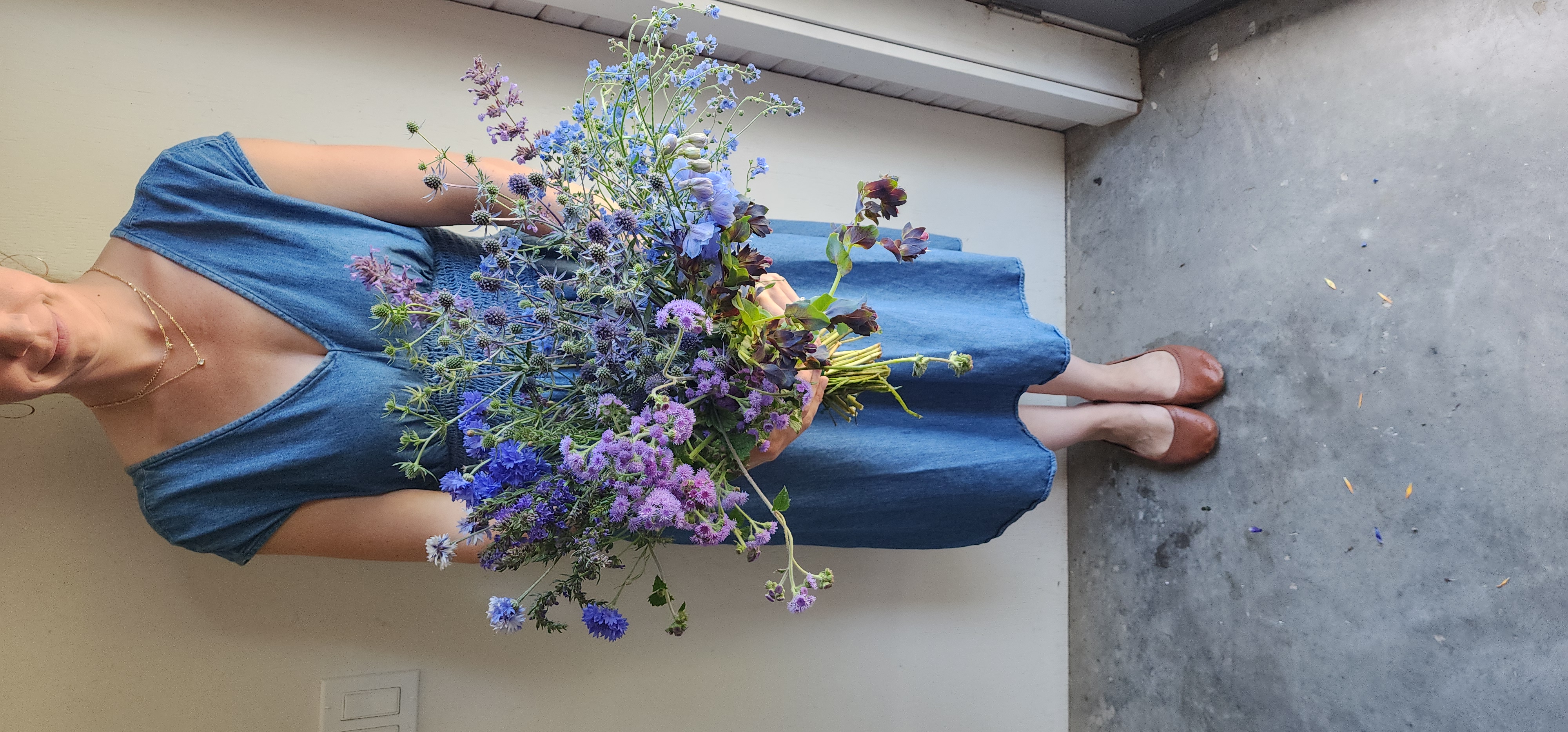 Paula holding a bundle of blue flowers