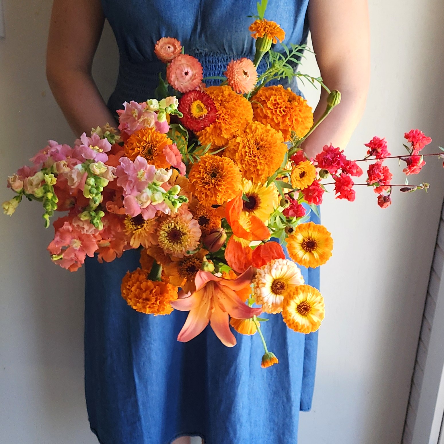 Paula holding a bundle of orange flowers