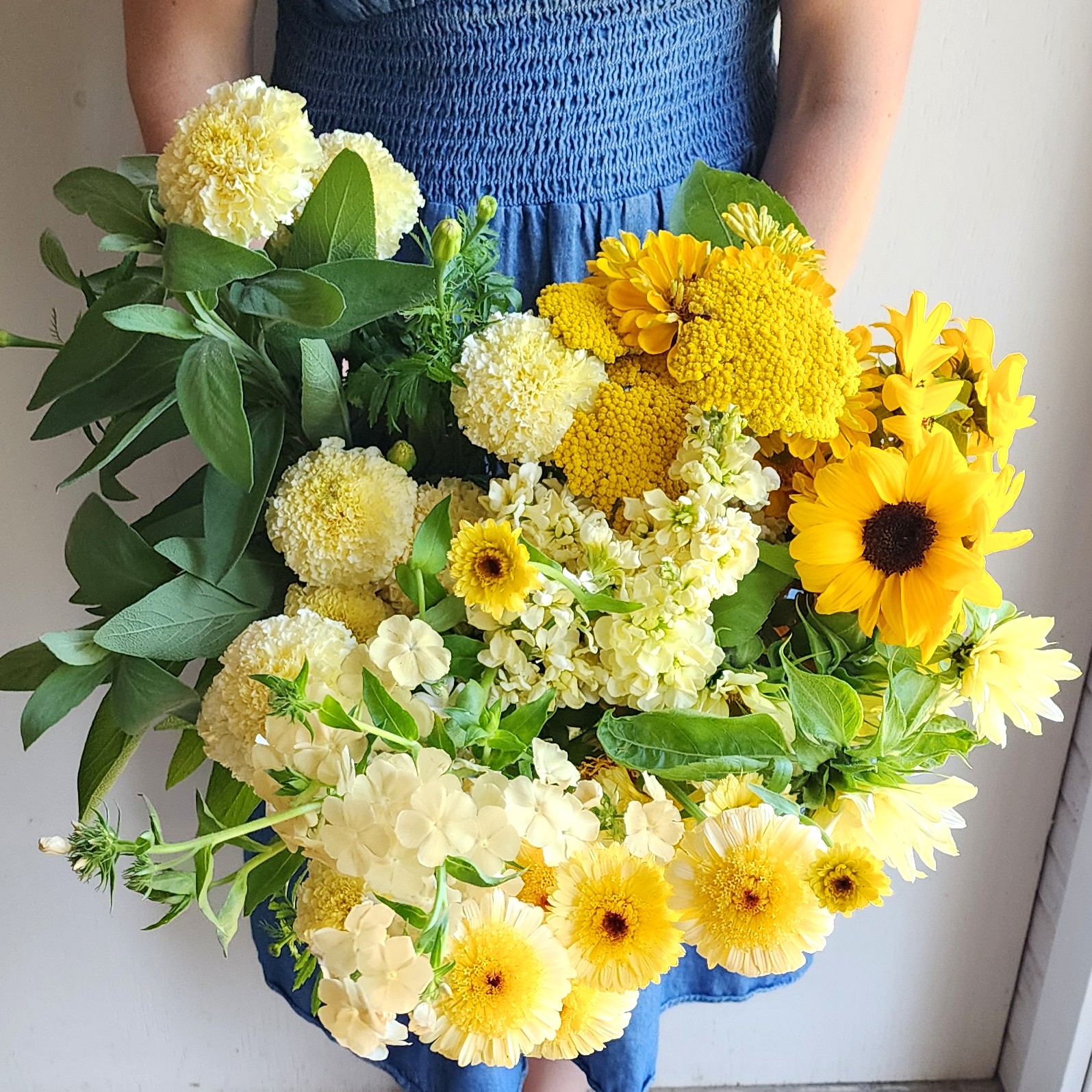 Paula holding a bundle of yellow flowers