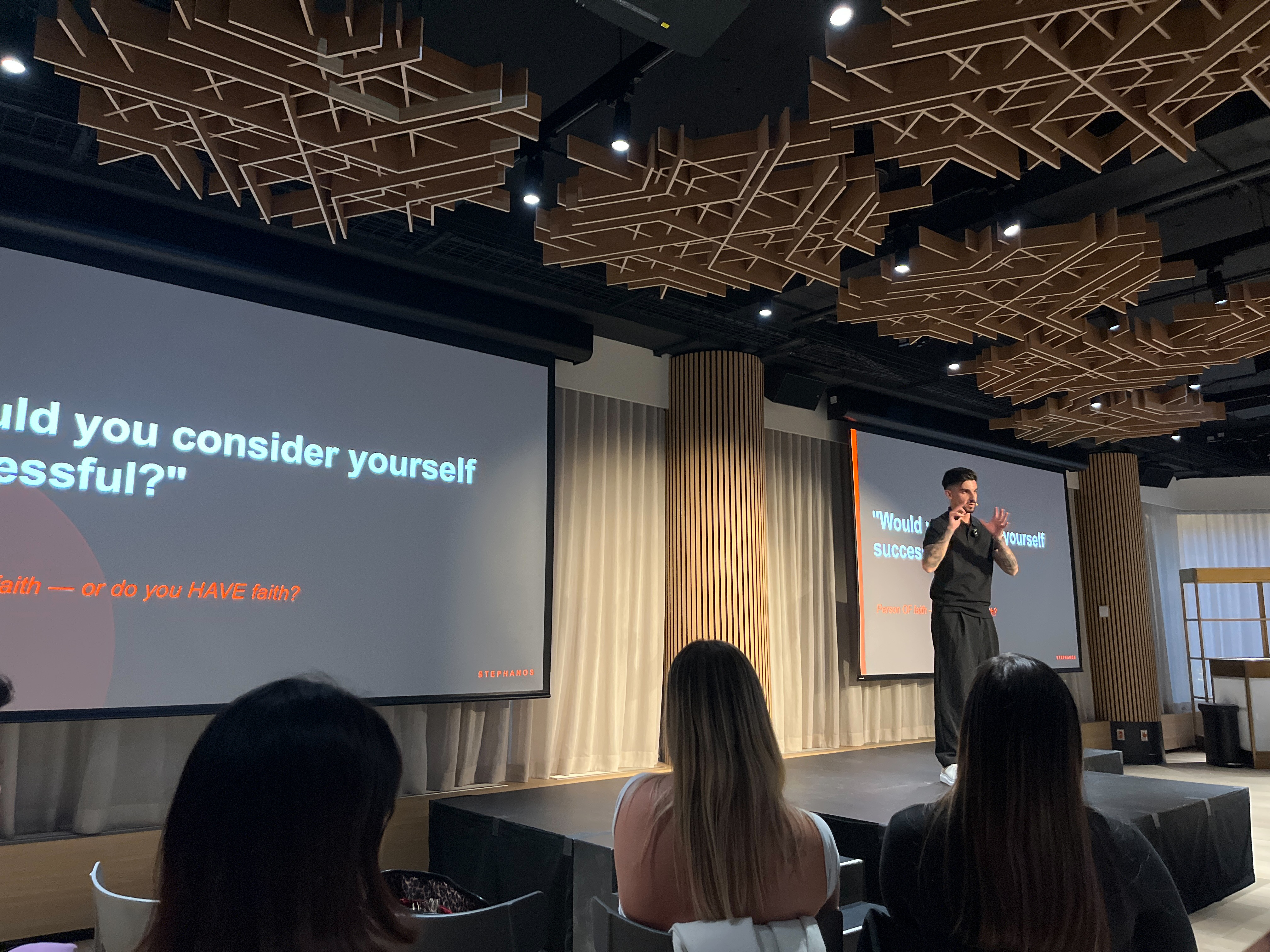 Stephanos presenting on stage at The Sales Revolution live event with attendees seated in the foreground