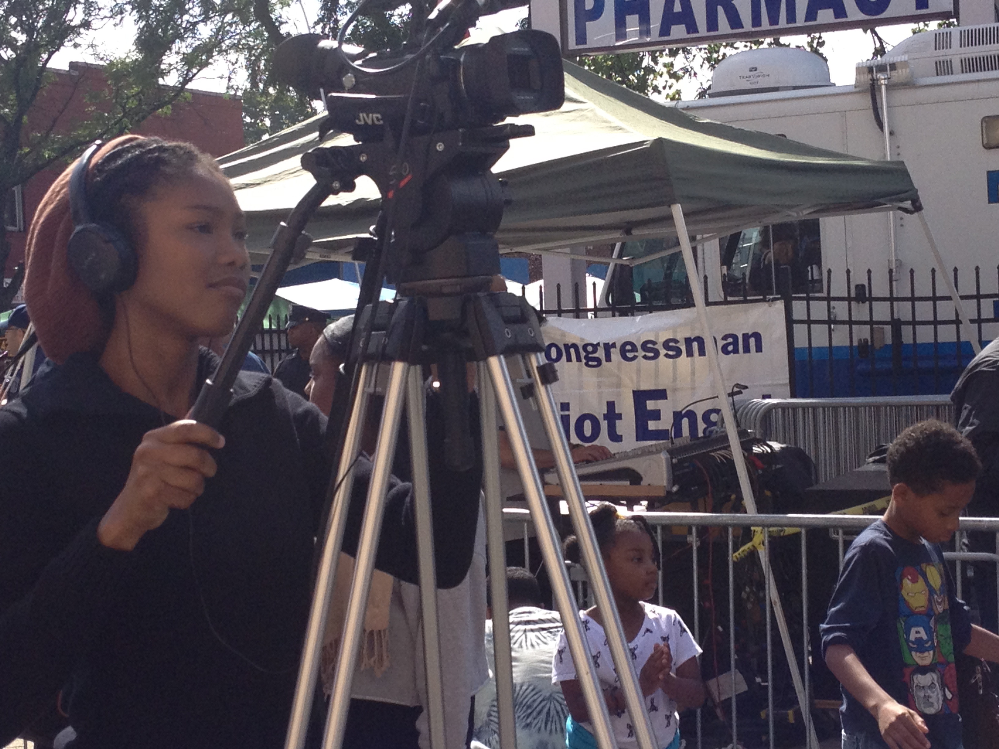 Student operating a professional video camera during EVT media training program in a community setting