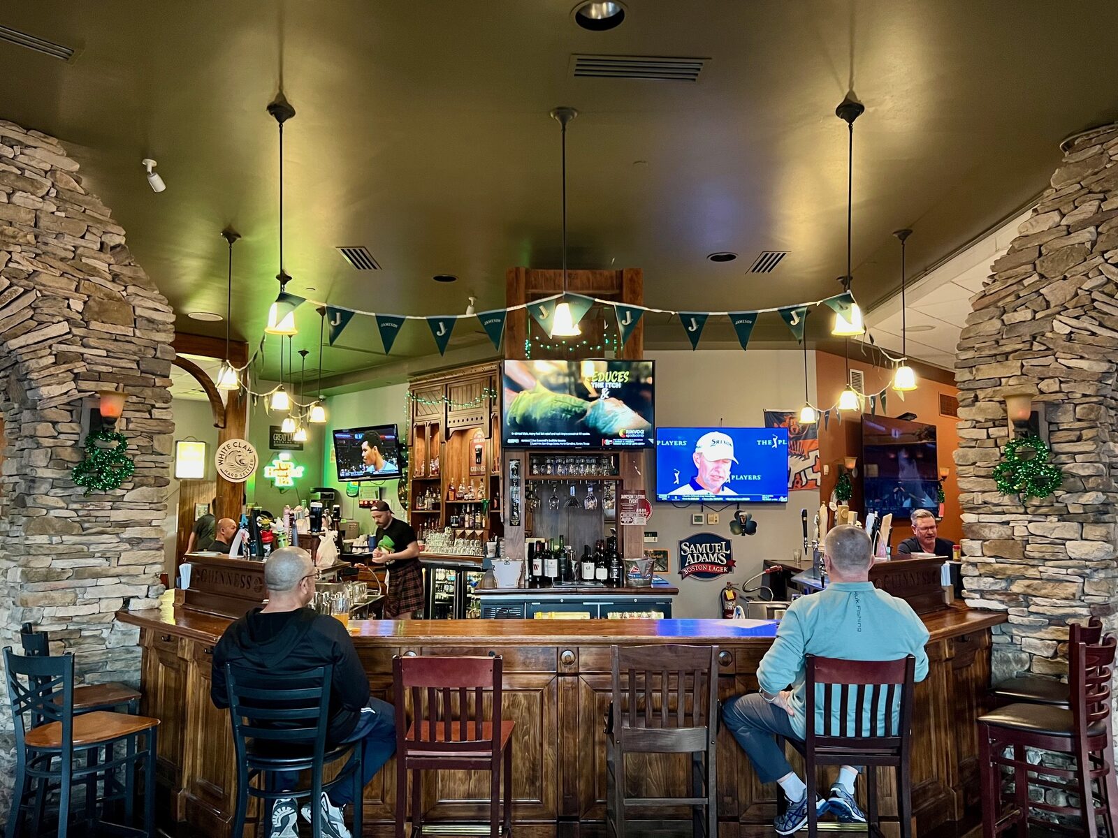 Guests at the bar under the stone arches