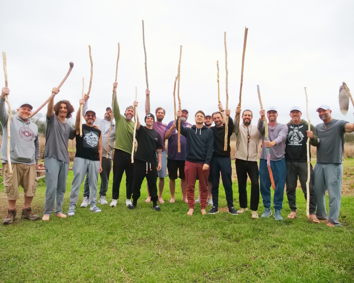 Men holding ceremonial staffs they crafted at The Men's Portal retreat