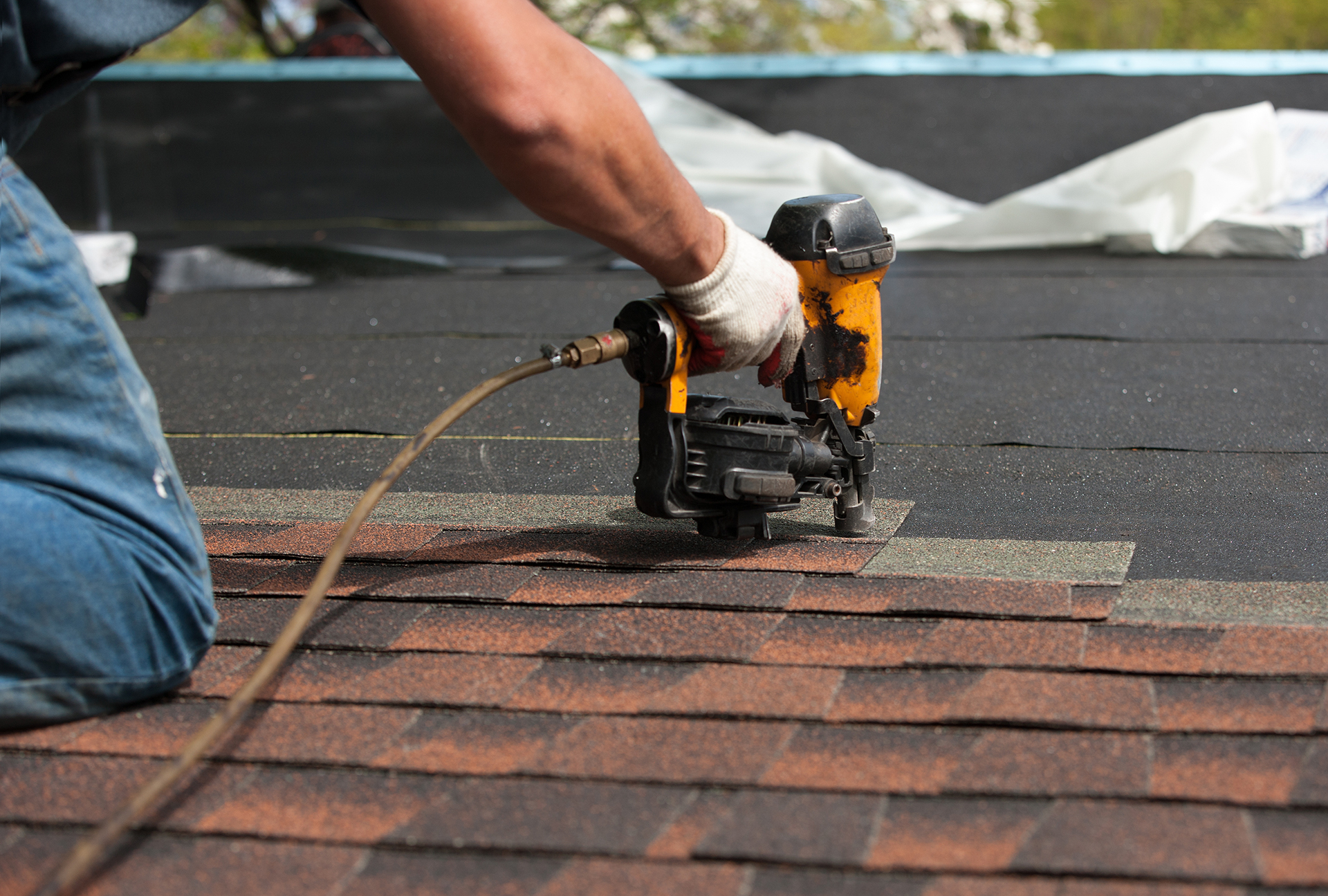 Roofing crew installing shingles