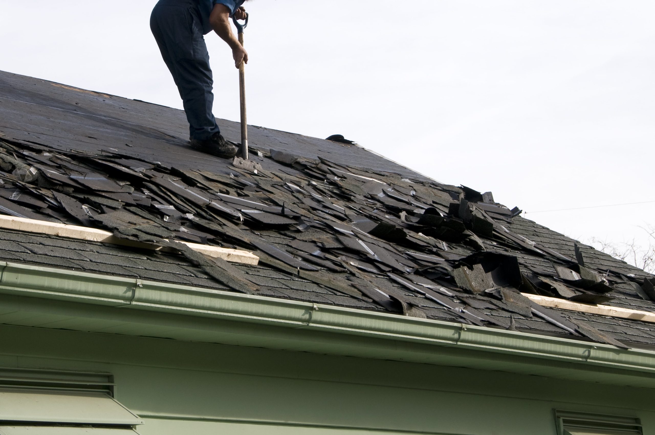 Damaged shingles being removed for repair