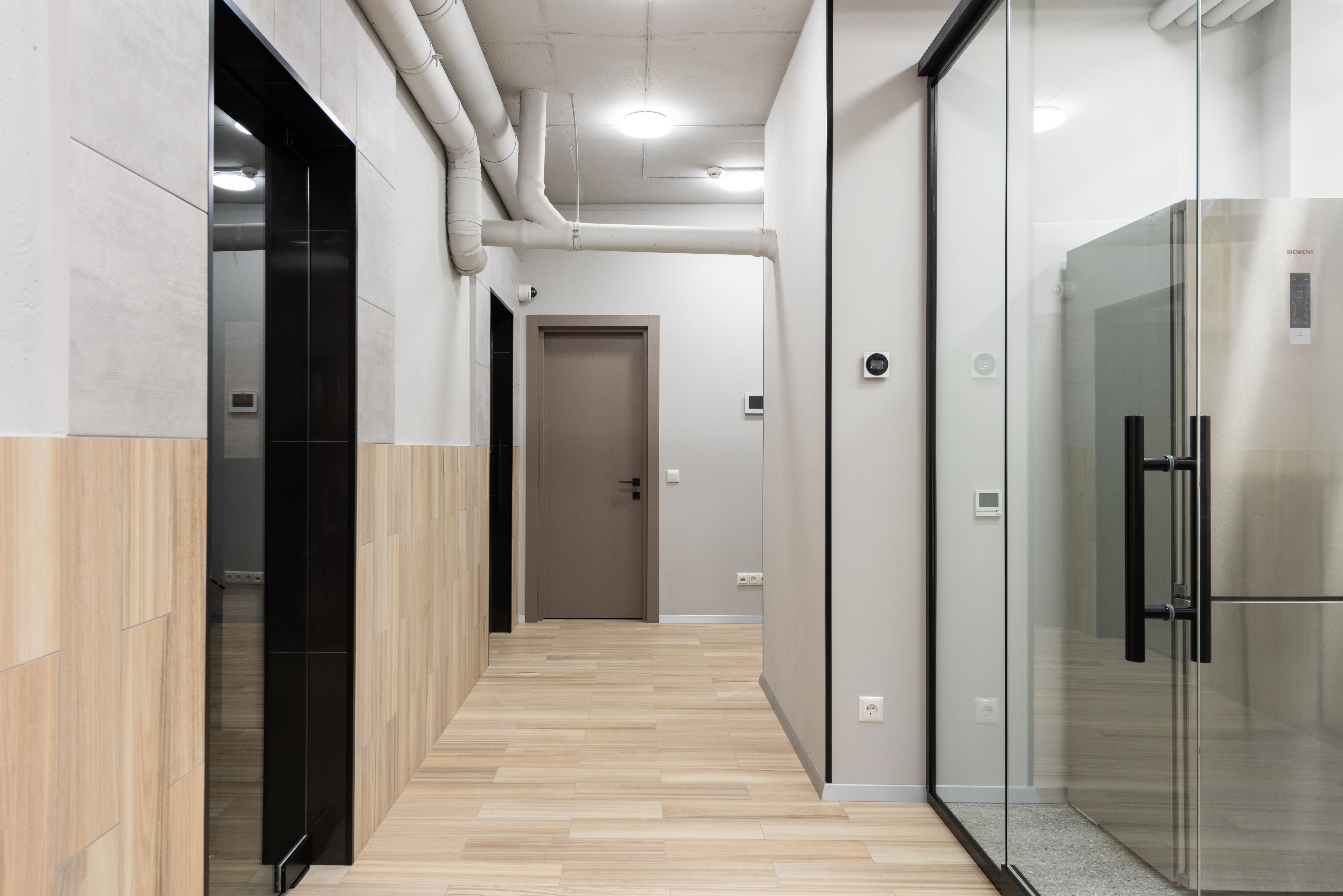 Modern commercial office corridor with ceiling lighting