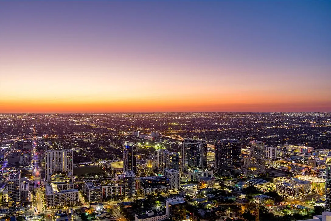 Aerial view of the Miami skyline glowing at dusk