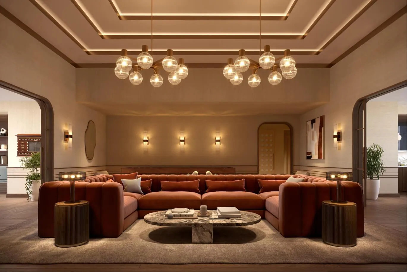 The great room with a rust-colored sofa and chandeliers
