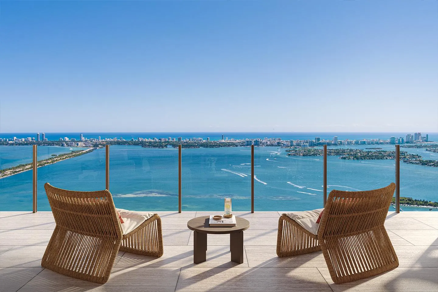 A residence terrace with lounge chairs facing the bay