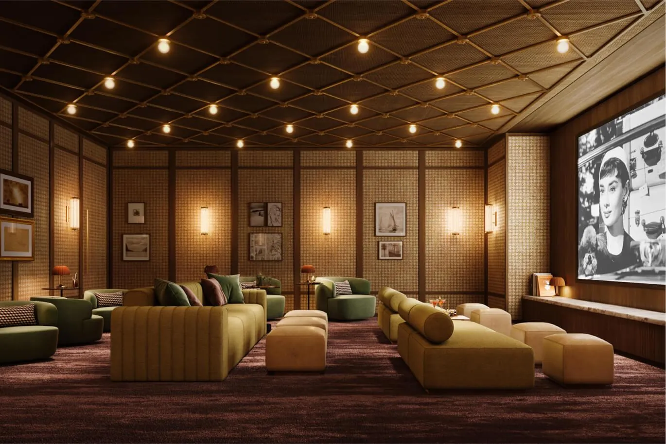 A screening room with deep sofas and a wall screen