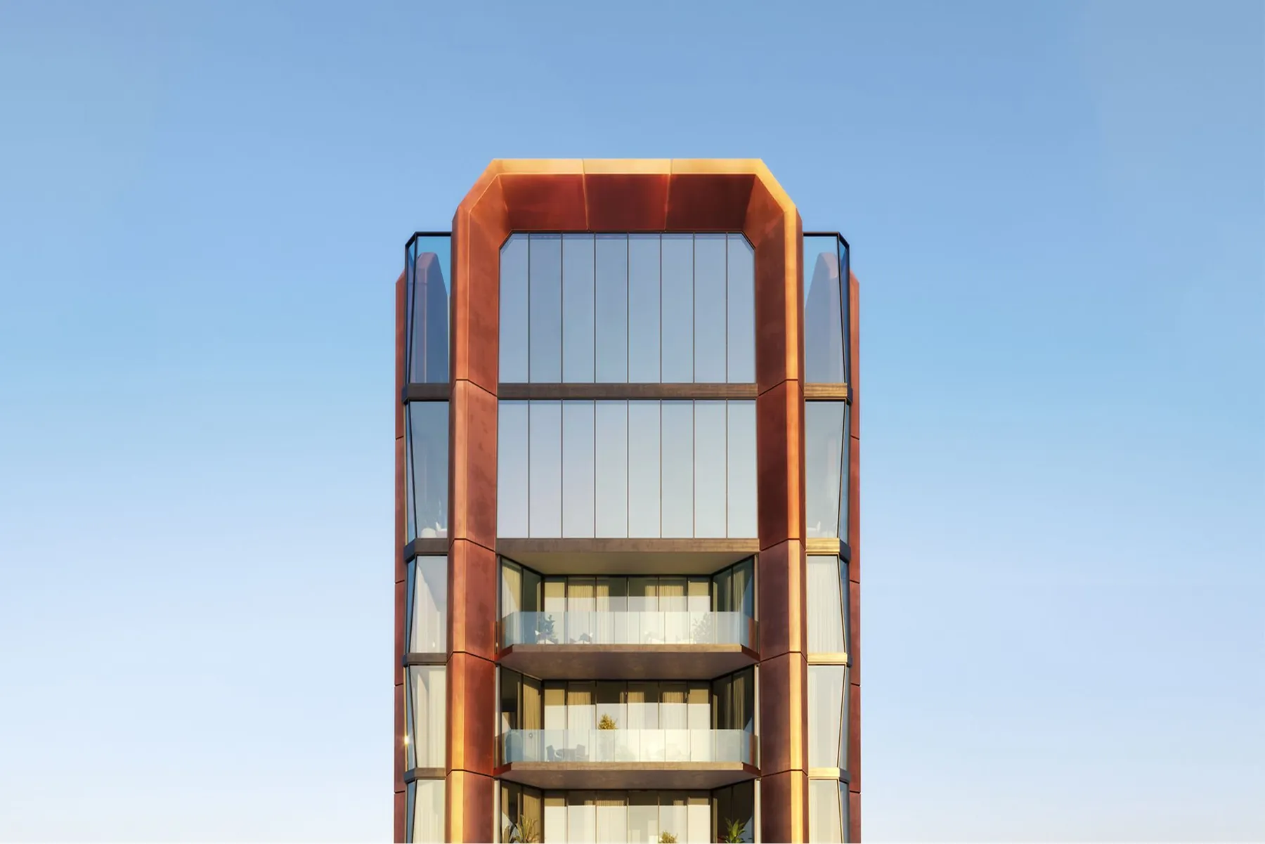 The copper frame at the crown of the tower against a clear morning sky