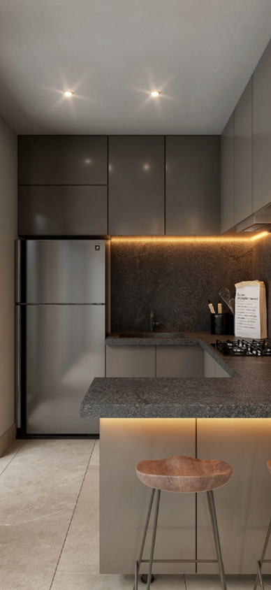 Cocina equipada con acabados modernos, barra de granito e iluminacion bajo gabinetes