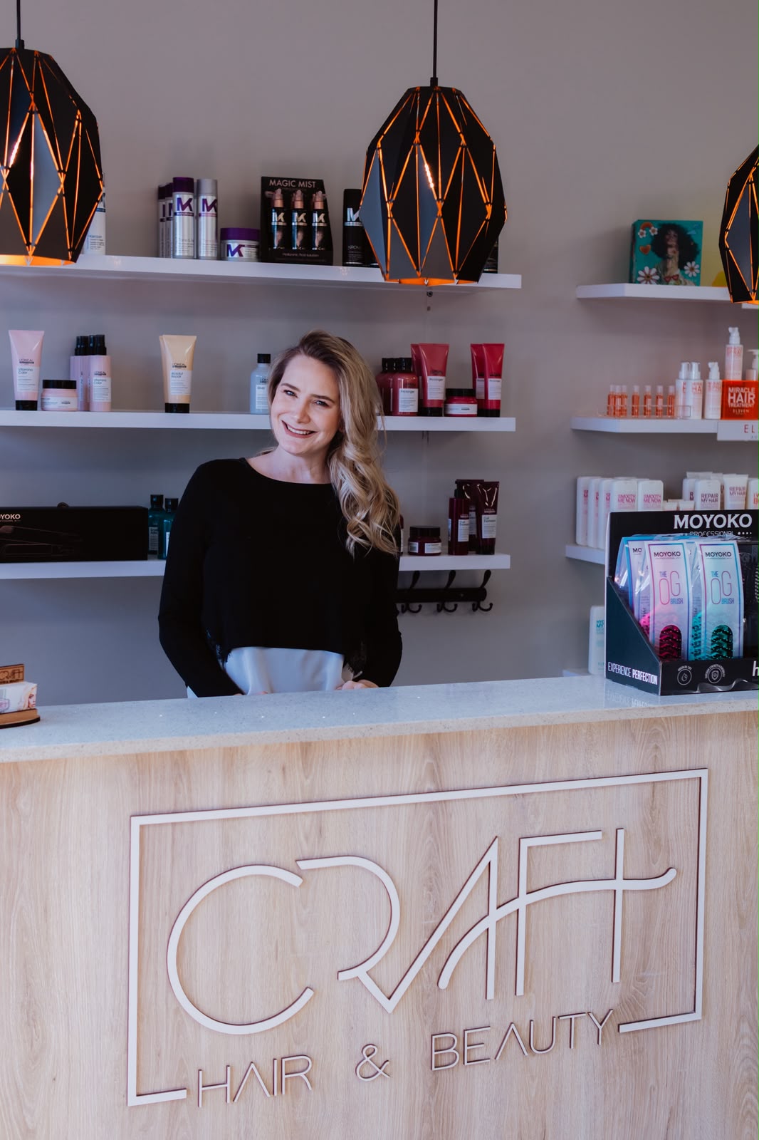 Rentia, owner of Craft Hair & Beauty, at the salon reception in Dainfern