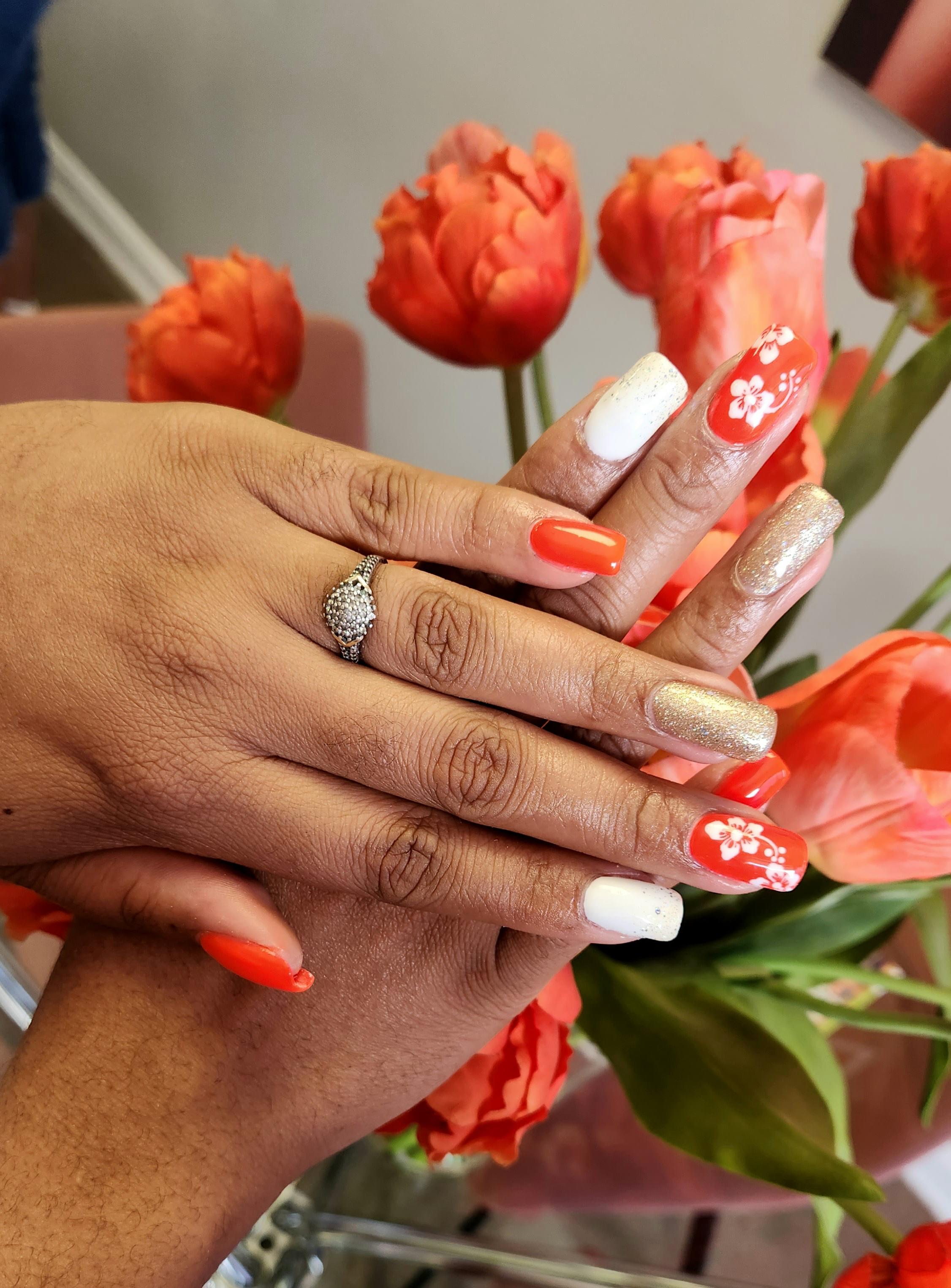 Orange floral-detail nail art created at Craft Hair & Beauty in Dainfern