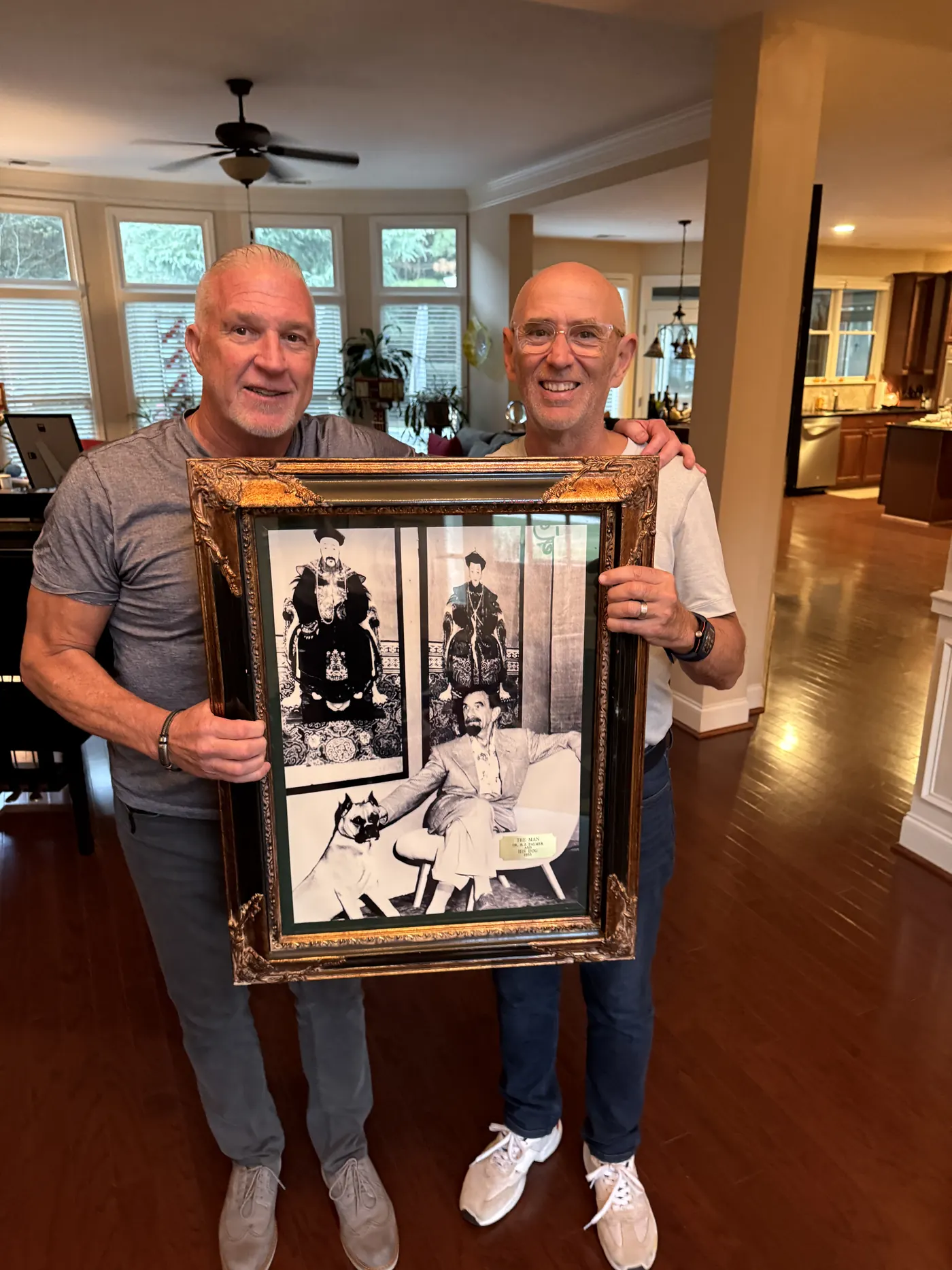 Dr. Randy Kale holding a framed portrait of B.J. Palmer