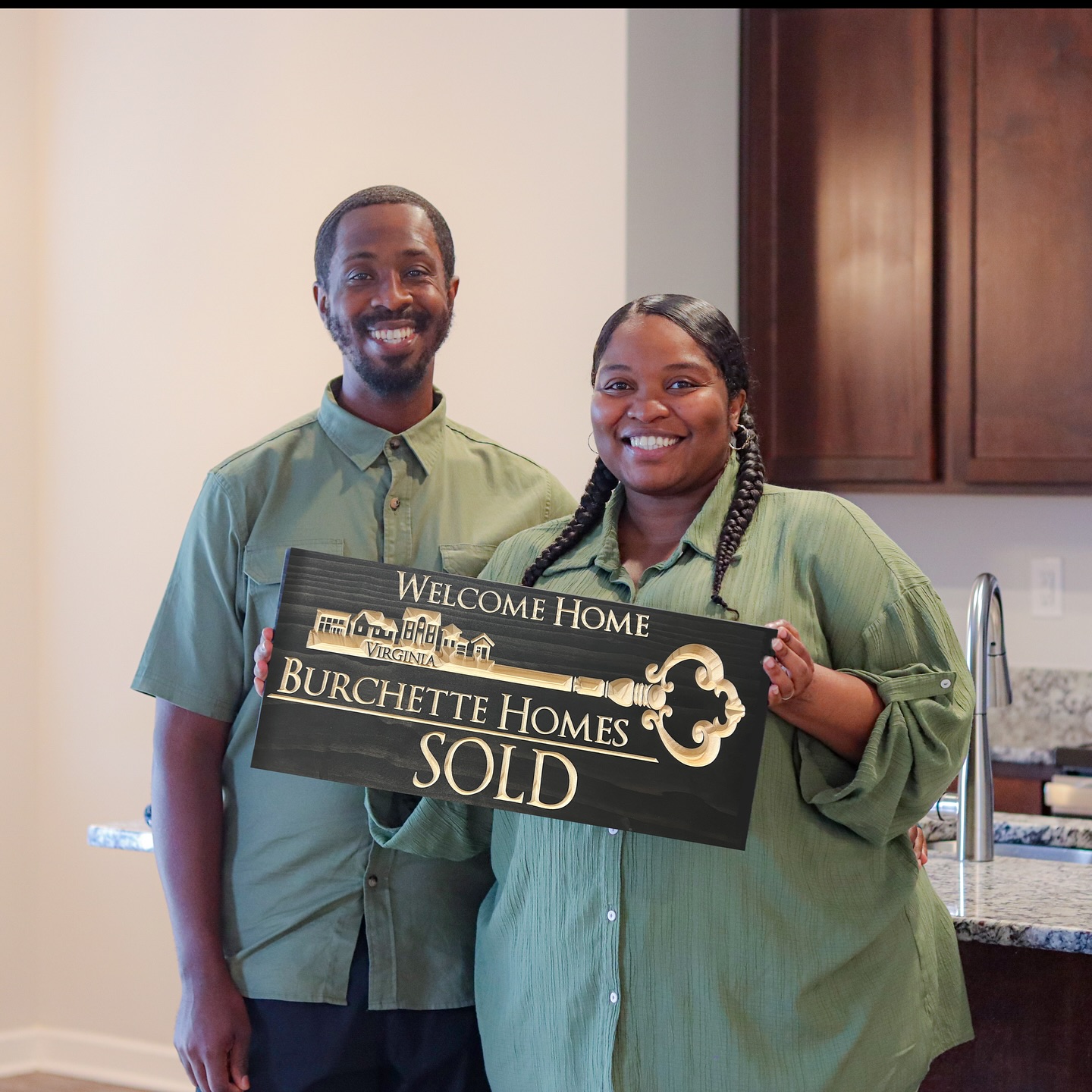 Burchette Homes closing photo with a SOLD sign.
