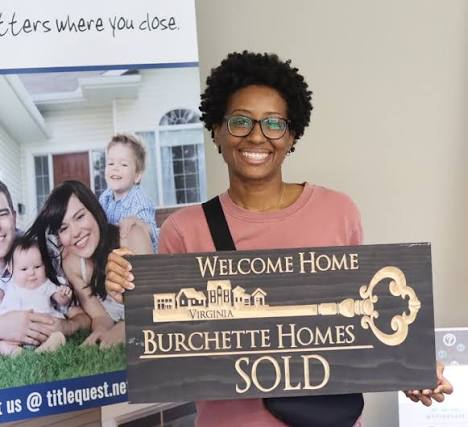 Burchette Homes closing photo with a SOLD sign.