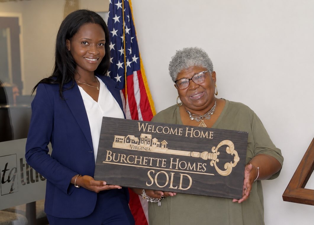 Burchette Homes closing photo with a SOLD sign.