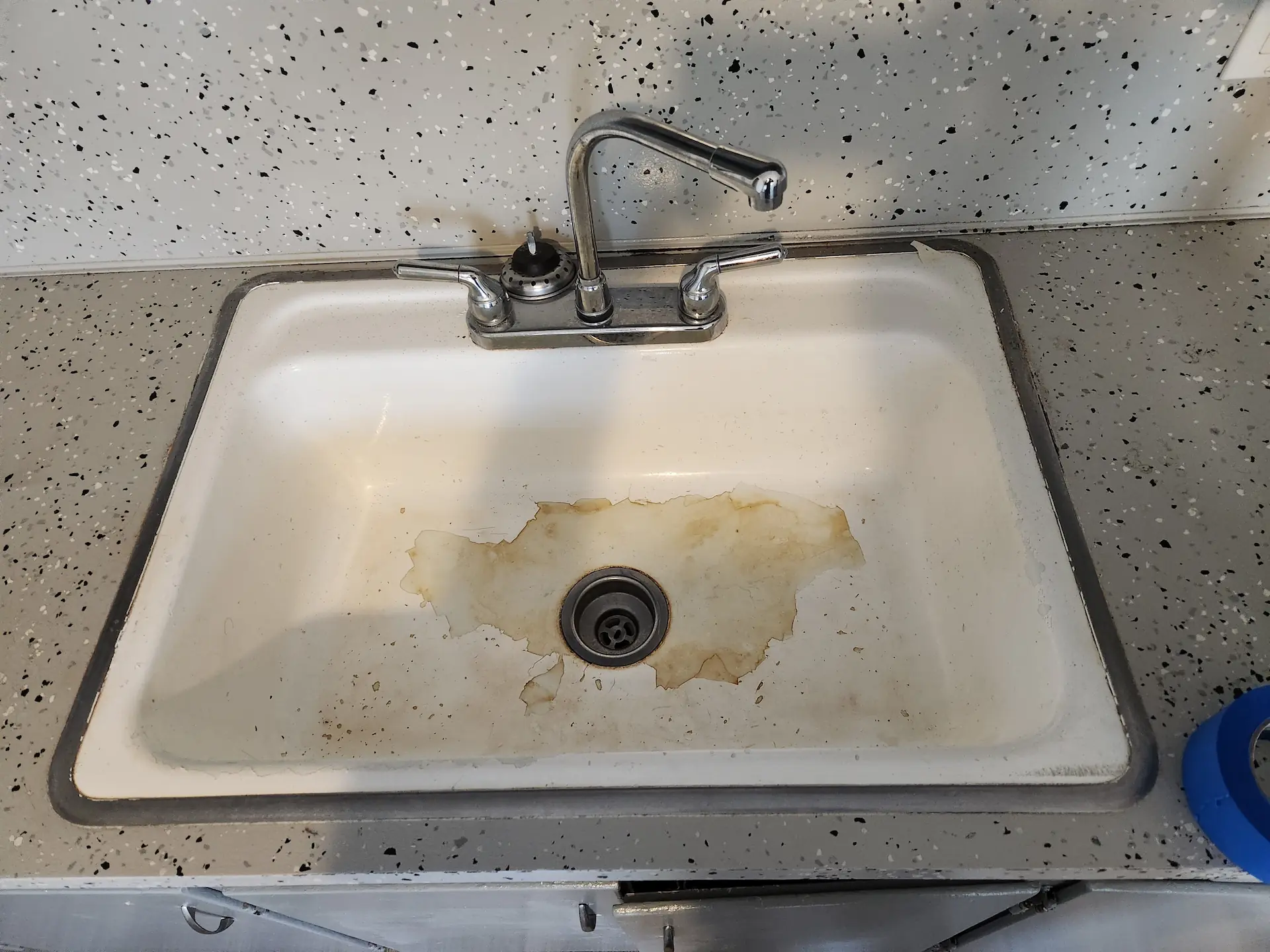 Stained kitchen sink before resurfacing in an Ohio home