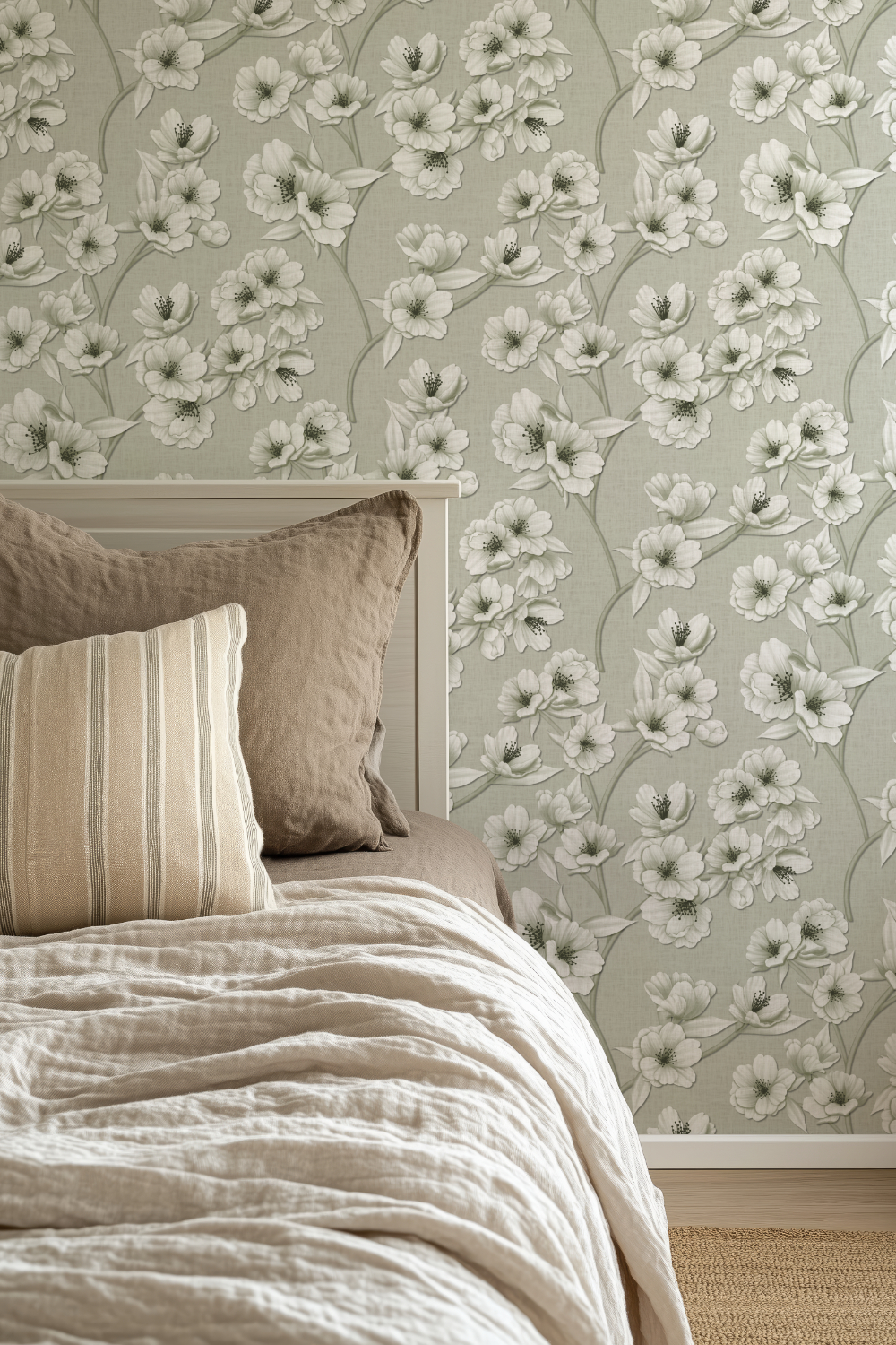 Soft greenish gray Japandi-style wallpaper featuring hand-drawn white cherry blossom branches with delicate textured details, styled in a modern bedroom with neutral linen bedding.