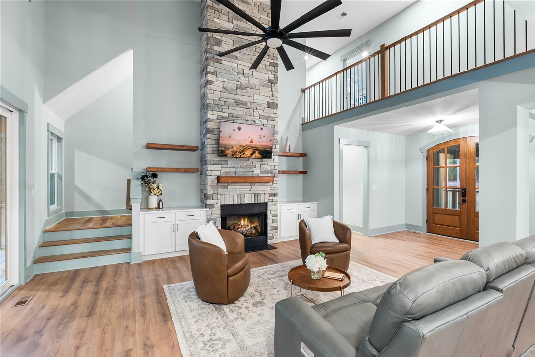 Great room with two-story fireplace and lake views