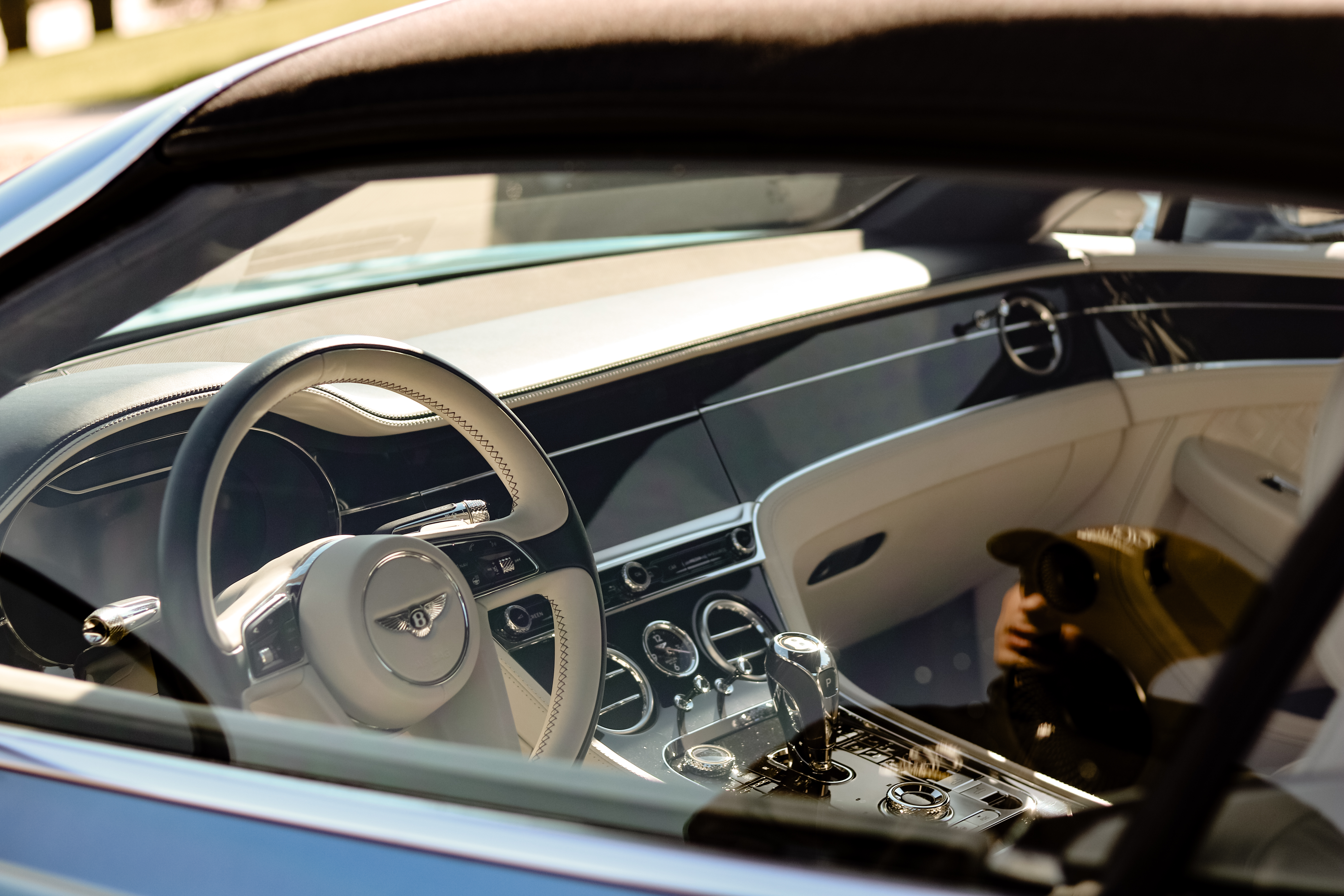 Image looking through a clean window of a detailed interior of a Bentley